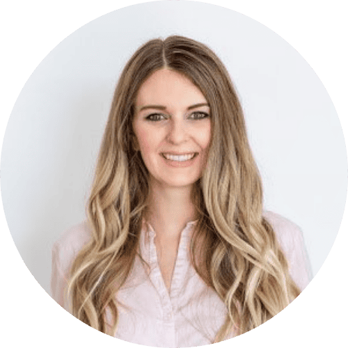 Woman smiling at the Spring 2022 Conference hosted by Root and Leaf Wellness, focusing on holistic health and wellness practices.