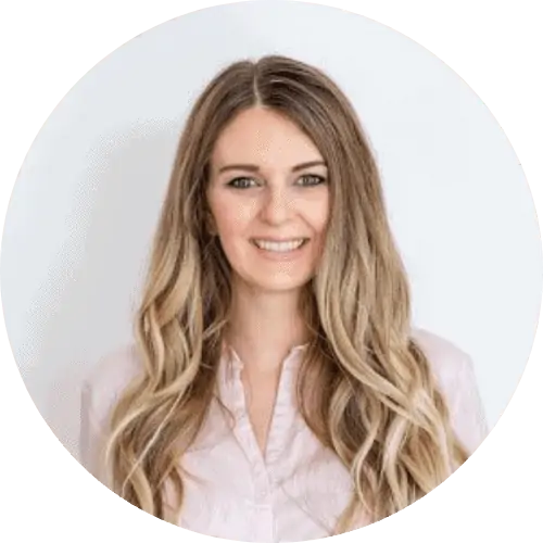 Woman smiling at the Spring 2022 Conference hosted by Root and Leaf Wellness, focusing on holistic health and wellness practices.